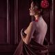 Romantic boudoir portrait of woman with flower in hair wrapping in bed... (thumbnail)