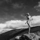 Nude woman standing on rocks in mountain landscape scenery wind blowin... (thumbnail)