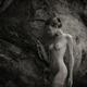 Nude woman in a cave with her naked body wrapped in a cobweb... (thumbnail)