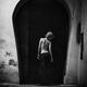 Nostalgic fine art portrait of a young woman standing with her back in... (thumbnail)