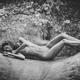 Black and white fine art nude photograph of a skinny young woman lying... (thumbnail)