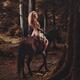 Half-naked young woman riding a horse in the forest... (thumbnail)