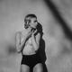 Black and white portrait of a topless young woman in high waist briefs... (thumbnail)