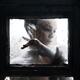 Dramatic expressive portrait of a woman face behind a closed dusty win... (thumbnail)