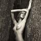 Fine art black and white sepia portrait of a topless young woman leani... (thumbnail)