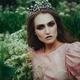 Mythical beauty portrait of a woman in a princess crown in a field of... (thumbnail)