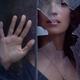Woman face looking from behind a broken window glass drama and mystery... (thumbnail)