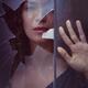 Dramatic conceptual portrait of a woman face behind a broken window pa... (thumbnail)