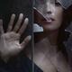 Dark moody portrait of woman face behind a broken window glass... (thumbnail)
