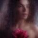 Dream-like romantic portrait of a woman face with a rose behind a hazy... (thumbnail)
