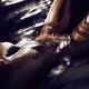 Fine art nude of woman with dark shiny metallic skin lying naked subme... (thumbnail)