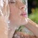 Woman face showering under fresh pouring water natural beauty care... (thumbnail)