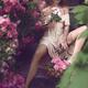 Romantic beautiful woman sitting in a garden in a summer dress with he... (thumbnail)