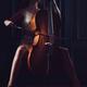 Beautiful sensual woman passionately playing cello in dim dramatic nig... (thumbnail)