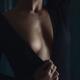 Sensual closeup of a woman in a black dress with a low-cut cleavage re... (thumbnail)