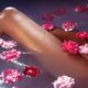 Artistic closeup of nude woman legs in a bath with pink roses floating... (thumbnail)