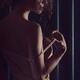 Sensual portrait of a woman taking off a shoulder strap of her camisol... (thumbnail)