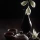 Zen still life of a clay teapot with tea cups and flowers in antique v... (thumbnail)