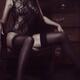 Mysterious seductive woman in black lace bodysuit and stockings sittin... (thumbnail)