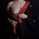 Mysterious woman with white skin taking off black and red kimono revea... (thumbnail)