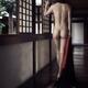 Nude asian woman walking along a dark corridor in Japanese house looki... (thumbnail)
