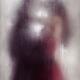 Sensual couple kissing standing behind wet glass in an embrace Dreamy... (thumbnail)