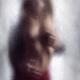 Sexy couple behind wet glass Man hands caressing beautiful half naked... (thumbnail)