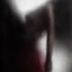 Sensual couple behind wet glass man holding a woman by the waist... (thumbnail)