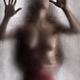 Half nude woman leaning against the glass with man hands around her wa... (thumbnail)