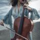 Woman passionately playing cello on ocean shore with her hair flying i... (thumbnail)