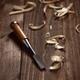 Artistic carpentry still life of a chisel and wood shavings on a table... (thumbnail)