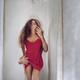 Sexy young woman in red nightgown reflecting in a mirror with mans han... (thumbnail)