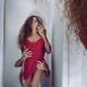 Sexual fantasy of a beautiful woman in red night shirt reflecting in a... (thumbnail)