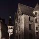 Narrow old street in medieval town lit by a street lamp at night Franc... (thumbnail)