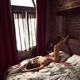Artistic erotic portrait of a nude sexy woman lying relaxed on a bed a... (thumbnail)