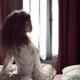 Beautiful sexy woman sitting in bed just awaken wearing sheer nightgow... (thumbnail)