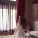 Woman thoughtfully sitting on the side of a bed in French bedroom in w... (thumbnail)