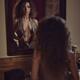 Woman undressing in front of a mirror with a thoughtful expression Sen... (thumbnail)
