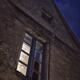 Closed lit from inside window of an old house at night in South of Fra... (thumbnail)