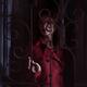 Woman standing behind locked grates touching the metal bars in a dark... (thumbnail)