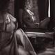 Black and white portrait of a sexy young woman sitting topless by the... (thumbnail)