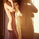 Young nude woman with messy hair standing naked in bright morning sunl... (thumbnail)