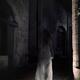 Transparent ghost of a woman in white dress walking along an old stree... (thumbnail)
