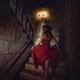Woman on a staircase of an old house running barefoot upstairs in fear... (thumbnail)