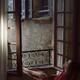 Woman resting in a chair by an open windows in France holding a cup of... (thumbnail)