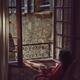 Woman sitting thoughtfully in a chair by an open windows in France hol... (thumbnail)