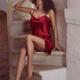 Sexy young woman in red silk nightgown sitting on a staircase of a Fre... (thumbnail)