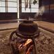 Cast iron kettle Kama boiling on fire in a sunken hearth Irori in a fl... (thumbnail)