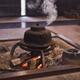 Steaming cast iron kettle Kama on firewood in a Japanese tea house... (thumbnail)