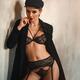 Sexy woman standing half naked in black lacy lingerie with garter belt... (thumbnail)